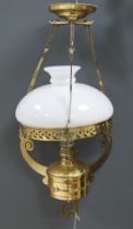 A late 19th century German brass hanging lamp, with oil reservoir and opaque glass shade,