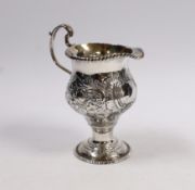 An early George III silver inverted pear shaped cream jug, with later embossed decoration, London,