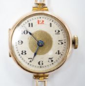 An early 20th century 9ct gold manual wind wrist watch, on a 9ct expanding bracelet, case diameter