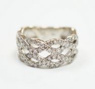 A modern 14k white metal and diamond chip cluster set dress ring, of interwoven design, size M,