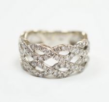 A modern 14k white metal and diamond chip cluster set dress ring, of interwoven design, size M,