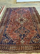 An antique Qashqai red ground rug, 260 x 174cm