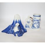 An early 19th century Japanese Hirado blue and white model of a monk seated by Mount Fuji, and a