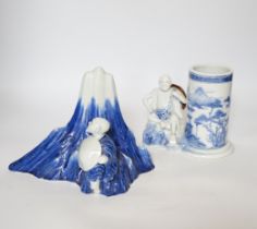 An early 19th century Japanese Hirado blue and white model of a monk seated by Mount Fuji, and a