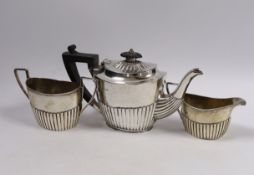 A matched late Victorian demi fluted three piece tea set, gross weight 16oz.
