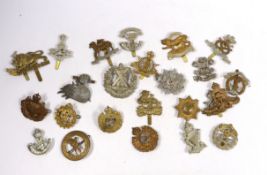 Twenty-five military cap badges including Royal Engineers, The Kings Own, Royal Warwickshire,