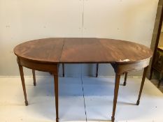 A George III mahogany D-end extending dining table with two leaves