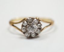 An early 20th century 18ct and old round cut diamond set circular cluster ring, size Q, gross weight
