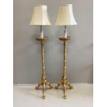 A pair of 18th century style carved gilt cluster column tripod standard lamps, height including