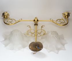 A brass pendant light and two opaque glass frilled shades, 60cm wide