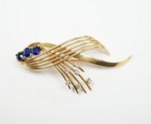 A yellow metal, sapphire and diamond cluster set stylised spray brooch, 52mm, gross weight 9.7