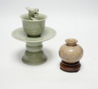 A Chinese celadon glazed 'dragon' puzzle cup and stand, early 20th century and a Chinese crackle