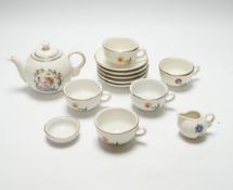 A child’s tea set comprising a teapot, five cups and saucers and a milk jug, teapot 8.5cm
