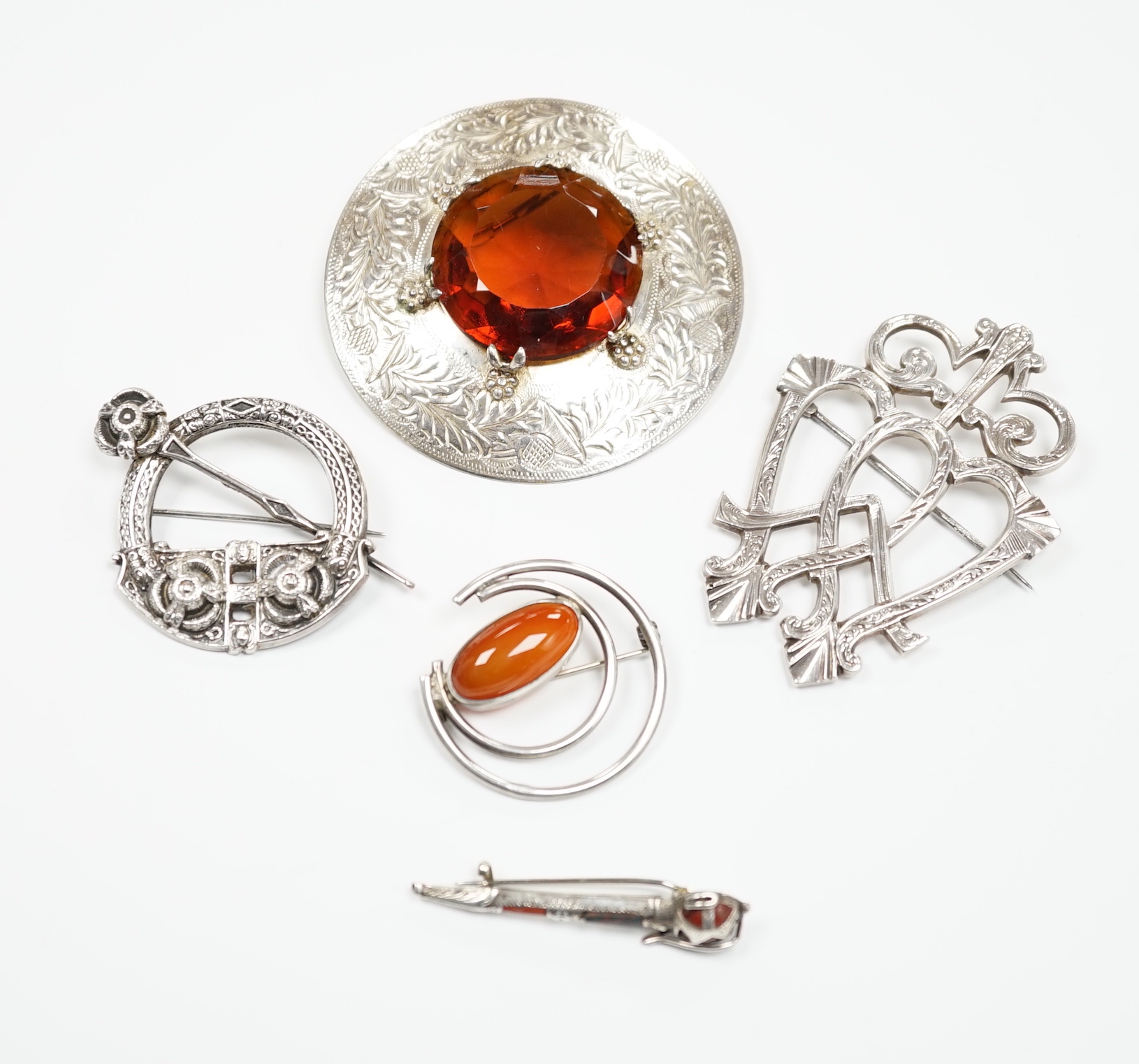 A 1950's Scottish silver and citrine coloured paste set circular brooch, 68mm, an Edwardian silver