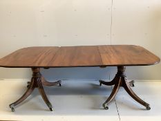 A Regency mahogany two pillar dining table, with one spare leaf. Length 206cm extended, depth 107cm,