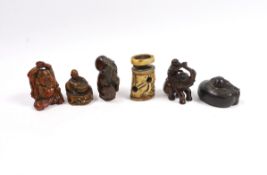 A group of six Japanese netsuke in wood, staghorn and lacquer, 19th century and later