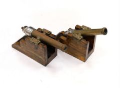 A near pair of breech loading brass and steel starting cannons, on elm stands, longest barrel 24.