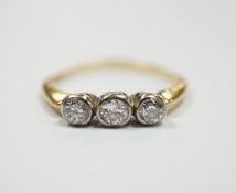 An 18ct and collet set three stone diamond ring, size R, gross weight 2.6 grams.