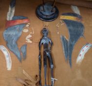 Two Native American paintings on leather and two carved hardwood figures, tallest hardwood figures