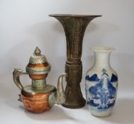 A Chinese bronze gu vase, a 19th century Chinese blue and white vase and a Tibetan teapot, tallest