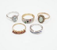 Four assorted 9ct and gem set rings, including opal and white sapphire?, blue topaz and diamond,