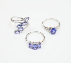 Three assorted modern 9ct white gold and tanzanite set dress rings, gross weight 8.4 grams.