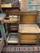 A 1920's oak hall seat/combined stick stand, width 84cm, depth 40cm, height 83cm