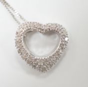 A modern 375 white metal and diamond chip set heart shaped pendant on chain, overall 42cm, gross