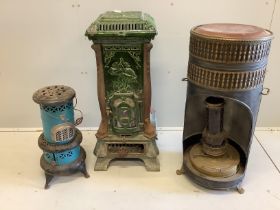 An early 20th century French enamelled cast iron heater, height 88cm and two other circular paraffin