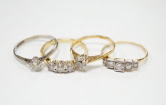 Four assorted 18ct and diamond set rings including a graduated five stone, three stone and two