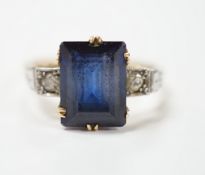 An 18ct, plat and single stone emerald cut synthetic? sapphire set dress ring with diamond set