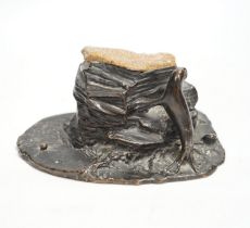 A bronze desk weight, a seal on rock, quartz mounted, 15cm wide