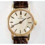 A lady's 1970's 9ct gold Omega manual wind wrist watch, with case back inscription, on associated