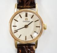 A lady's 1970's 9ct gold Omega manual wind wrist watch, with case back inscription, on associated
