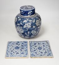 A 19th century Chinese blue and white prunus jar and cover, together with two similar tiles, jar