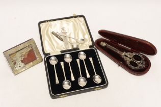 A cased pair of late Victorian repousse silver handled scissors and later silver thimble, a silver