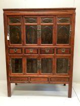 A Chinese lacquered pine side cabinet, width 134cm, depth 55cm, height 180cm