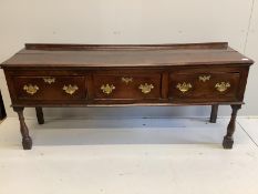 An 18th century oak low dresser, fitted with three drawers, raised on turned legs, length 184cm,
