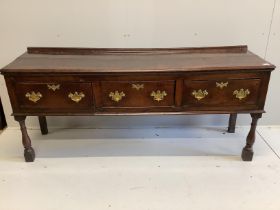 An 18th century oak low dresser, fitted with three drawers, raised on turned legs, length 184cm,