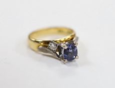An 18ct and single stone oval cut sapphire set dress ring, with diamond set shoulders, size I, gross