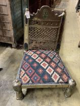 An Afghan metal mounted low chair with Kilim seat, width 59cm, depth 59cm, height 76cm