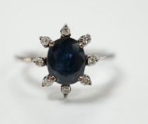 An 18k white metal, sapphire and diamond set cluster ring, size L, gross weight 2.5 grams.