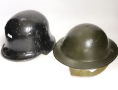 A German WW2 helmet and a British helmet