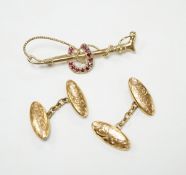 A pair of George V engraved 9ct gold oval cufflinks and a yellow metal and ruby cluster set