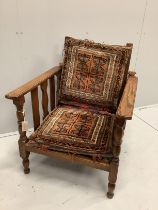 An early 20th century oak reclining elbow chair with Kilim seat and back, width 71cm, depth 78cm,