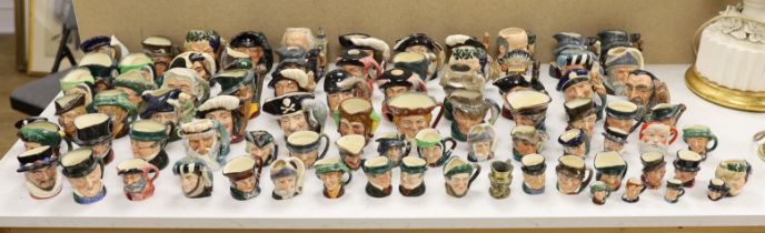 A large collection of Doulton character jugs including the Three Musketeers and Bacchus, largest