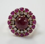 A yellow metal, ruby and diamond set circular cluster dress ring, with central cabochon ruby, size