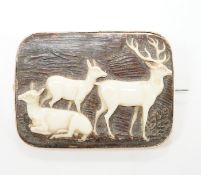 A yellow metal mounted staghorn brooch, carved with stag and deer, 48mm.