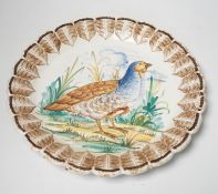 A set of Italian maiolica plates and serving dishes painted with central bird decoration within a