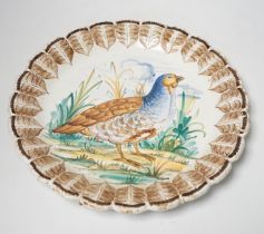 A set of Italian maiolica plates and serving dishes painted with central bird decoration within a